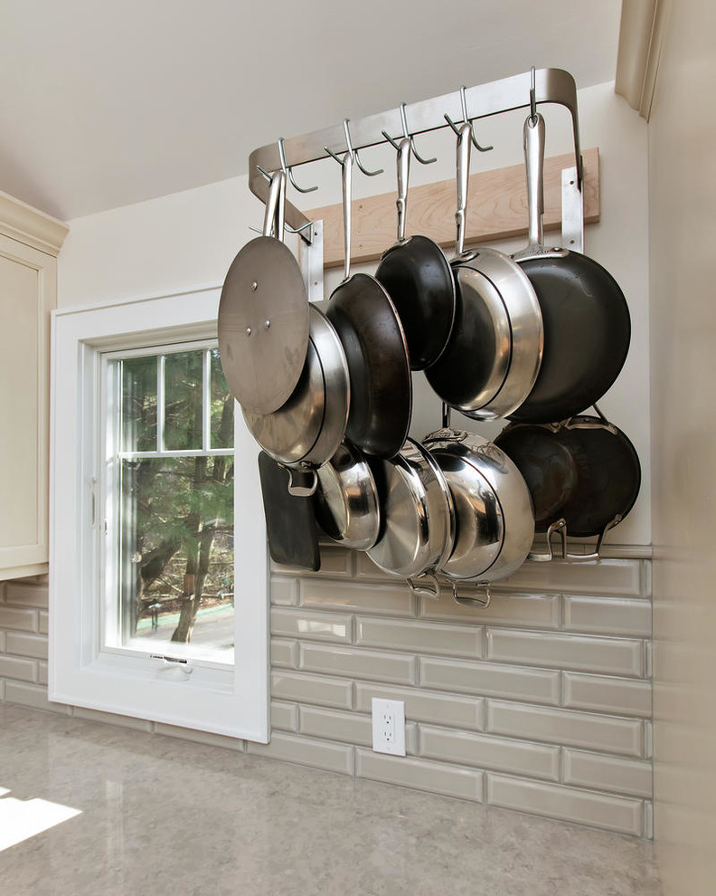 Example of a mid-sized transitional u-shaped porcelain tile eat-in kitchen design in New York with an undermount sink, recessed-panel cabinets, white cabinets, wood countertops, gray backsplash, subway tile backsplash, stainless steel appliances and an island