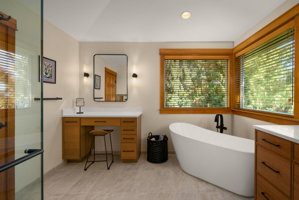 Inspiration for a transitional master bathroom in Seattle with a built-in vanity, flat-panel cabinets, medium wood cabinets, a freestanding tub, porcelain floors, engineered quartz benchtops and white benchtops.