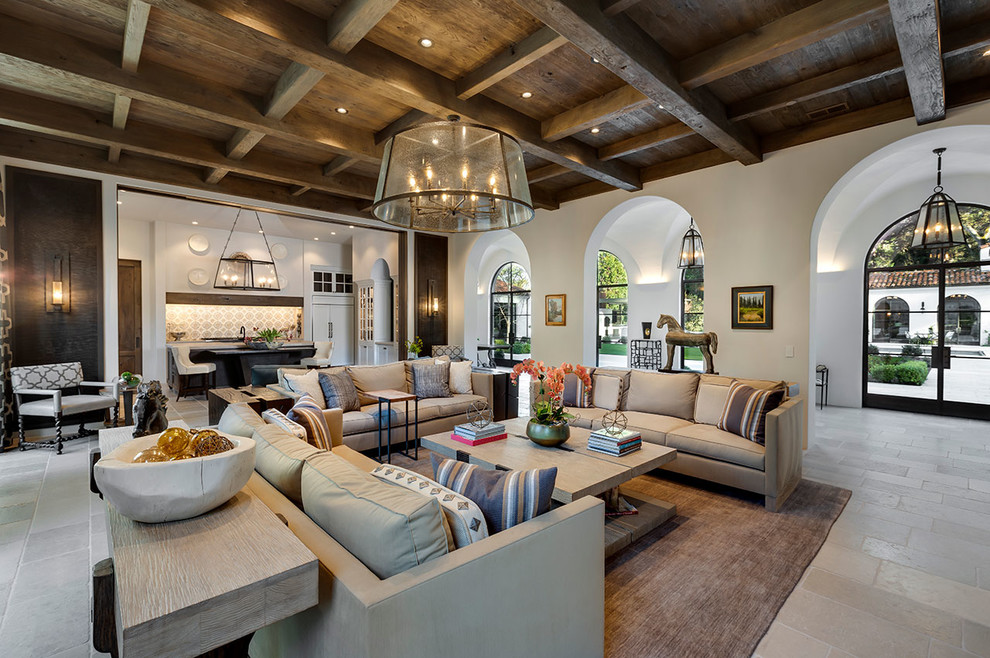 Expansive mediterranean open concept living room in Other with white walls, limestone floors and grey floor.