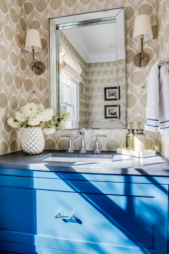 Design ideas for a small transitional powder room in Boston with recessed-panel cabinets, blue cabinets, a one-piece toilet, beige walls, medium hardwood floors, a console sink, soapstone benchtops and brown floor.
