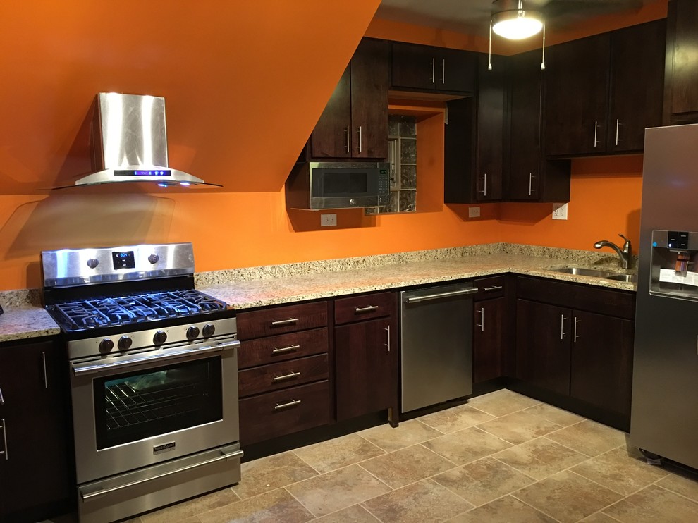 Mid-sized trendy l-shaped ceramic tile and beige floor eat-in kitchen photo in Chicago with a double-bowl sink, flat-panel cabinets, dark wood cabinets, granite countertops, multicolored backsplash, stone slab backsplash, stainless steel appliances and no island