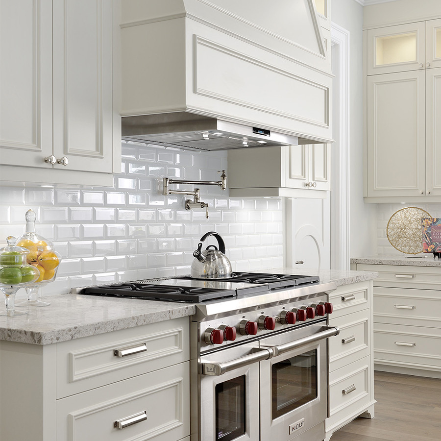 Inspiration for a large transitional u-shaped light wood floor, beige floor and coffered ceiling open concept kitchen remodel with an undermount sink, light wood cabinets, quartz countertops, white backsplash, subway tile backsplash, paneled appliances, an island, beige countertops and raised-panel cabinets