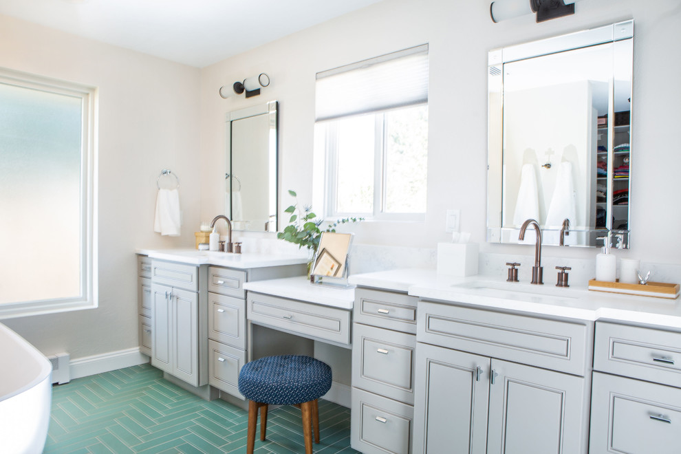 Large transitional master bathroom in Denver with raised-panel cabinets, grey cabinets, a freestanding tub, an alcove shower, a one-piece toilet, green tile, ceramic tile, white walls, ceramic floors, an undermount sink, engineered quartz benchtops, green floor, a hinged shower door and white benchtops.