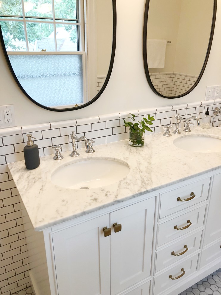 Design ideas for a mid-sized traditional master bathroom in Providence with furniture-like cabinets, white cabinets, a drop-in tub, white tile, ceramic tile, marble floors, an undermount sink, marble benchtops, white floor and grey benchtops.