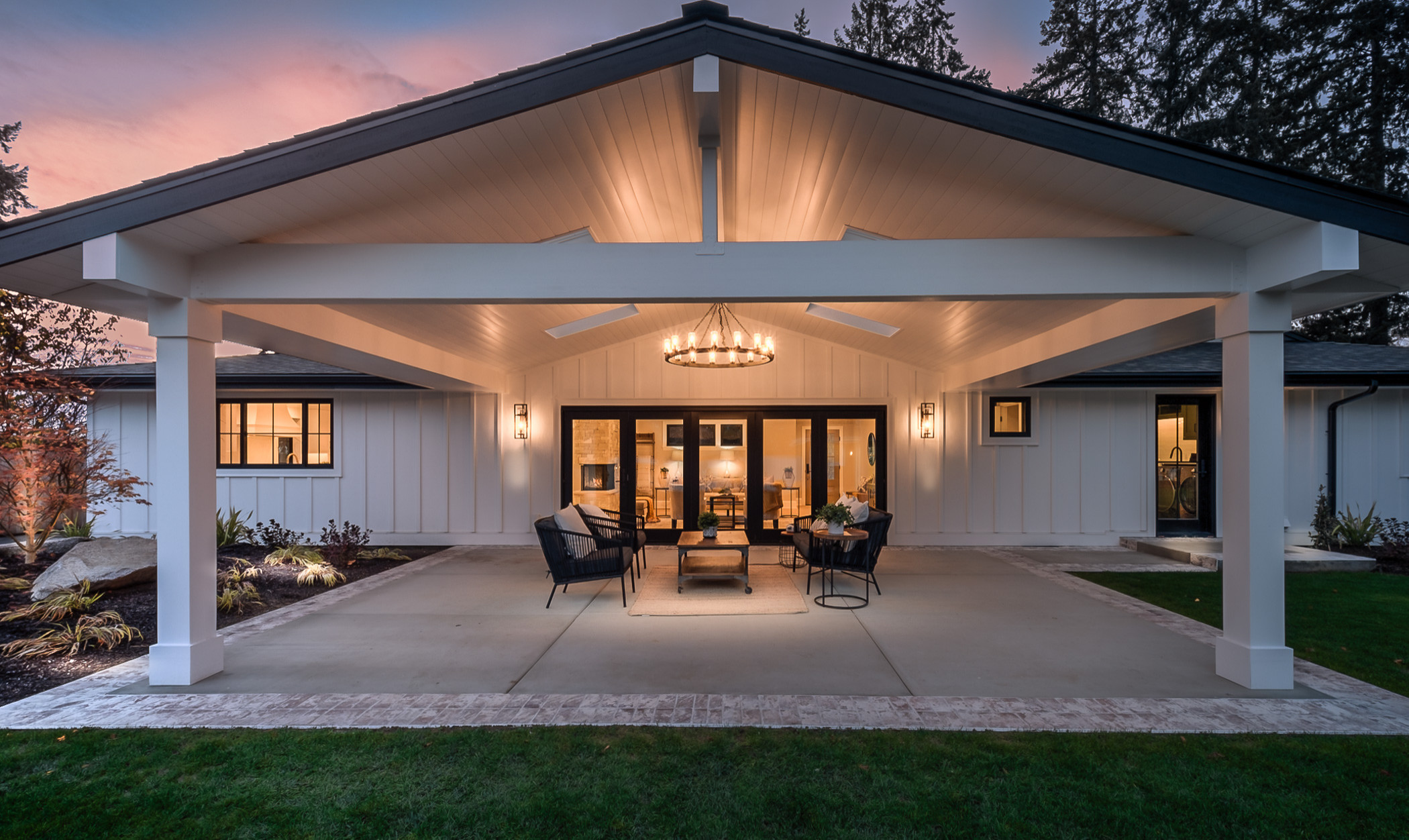 The transformation extends to the exterior with a beautifully landscaped yard and a spacious patio area, perfect for outdoor dining and relaxation.