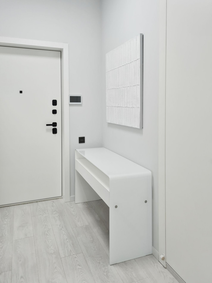 Large trendy vinyl floor and white floor entryway photo in Moscow with white walls and a white front door