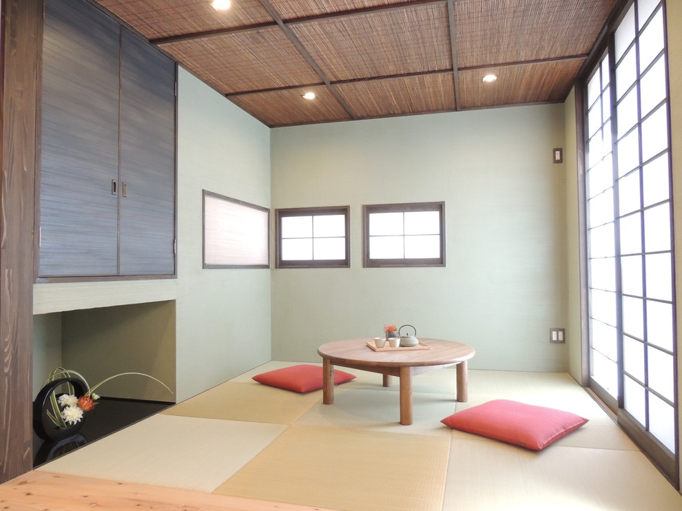 This is an example of an asian living room in Other with green walls, no fireplace, no tv, tatami floors and brown floor.