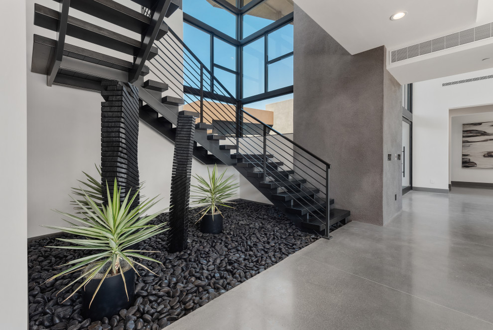 Photo of a mid-sized contemporary metal u-shaped staircase in Las Vegas with metal risers and metal railing.