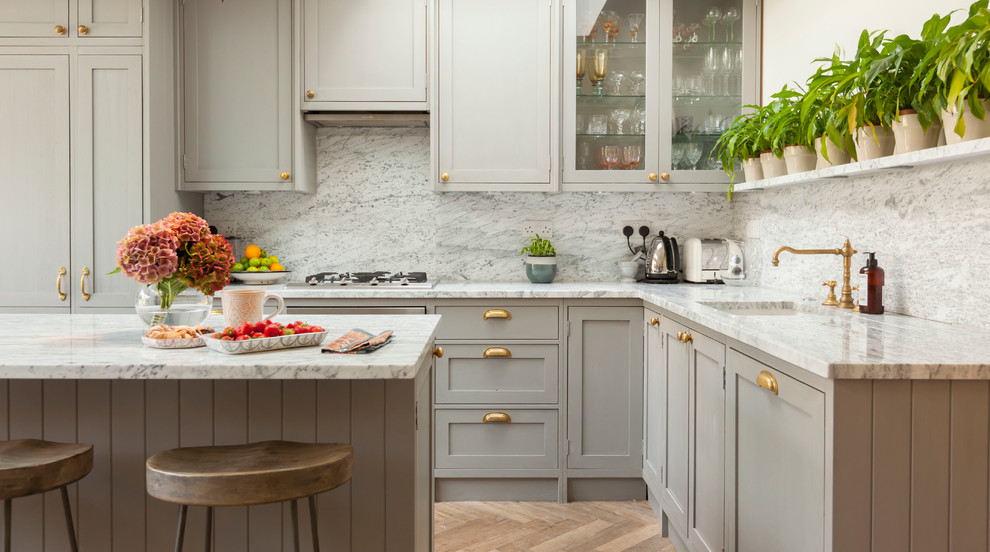 Inspiration for a transitional l-shaped kitchen in London with an undermount sink, shaker cabinets, grey cabinets, marble benchtops and with island.