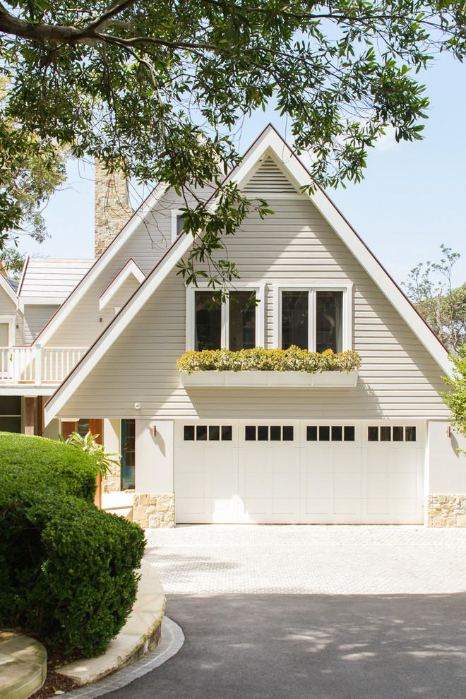 Inspiration for a beach style two-storey white house exterior in Sydney with a gable roof.