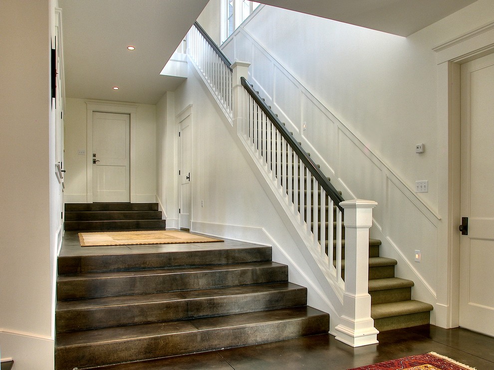 This is an example of a traditional carpeted straight staircase in Seattle with carpet risers.