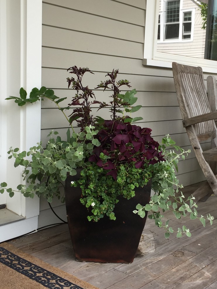 Inspiration for a farmhouse front porch remodel in Portland Maine with decking