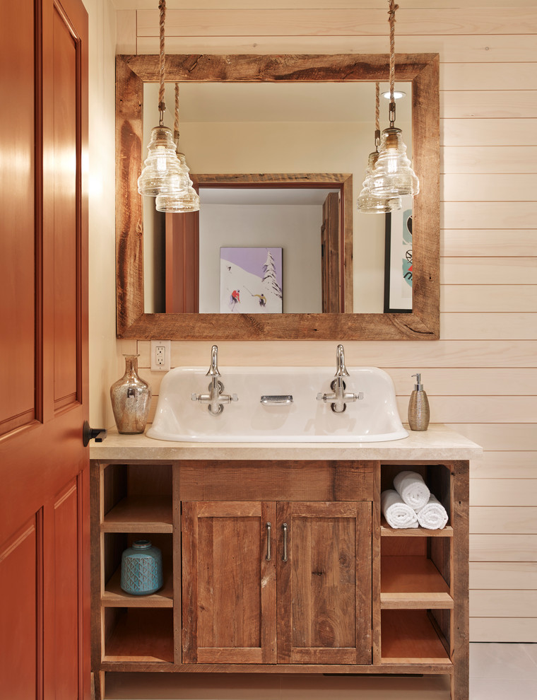 This is an example of a country bathroom in Houston with medium wood cabinets, a trough sink and shaker cabinets.