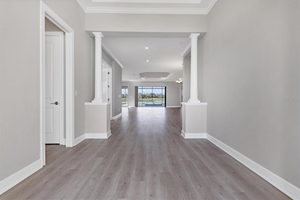 Large transitional entryway in Other with grey walls, laminate floors, a double front door, a white front door, multi-coloured floor and coffered.