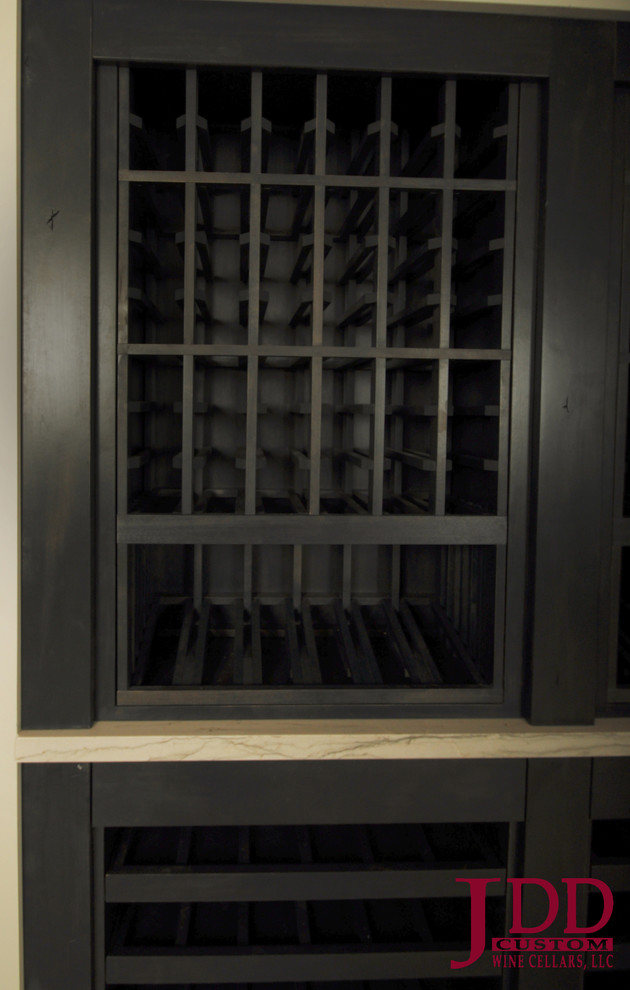 Mid-sized country wine cellar in San Diego with concrete floors and storage racks.