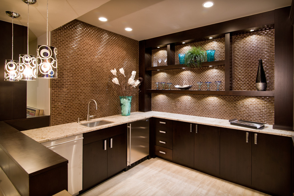 Photo of a large contemporary l-shaped home bar in Denver with an undermount sink, flat-panel cabinets, dark wood cabinets, granite benchtops, brown splashback and glass tile splashback.