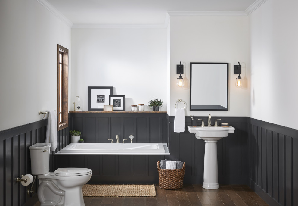 Example of a mid-sized trendy master single-sink drop-in bathtub design in New York with a two-piece toilet and a pedestal sink