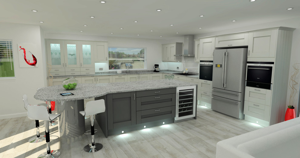 This is an example of a large contemporary l-shaped eat-in kitchen in Dorset with a drop-in sink, shaker cabinets, grey cabinets, granite benchtops, grey splashback, glass sheet splashback, stainless steel appliances, light hardwood floors and with island.