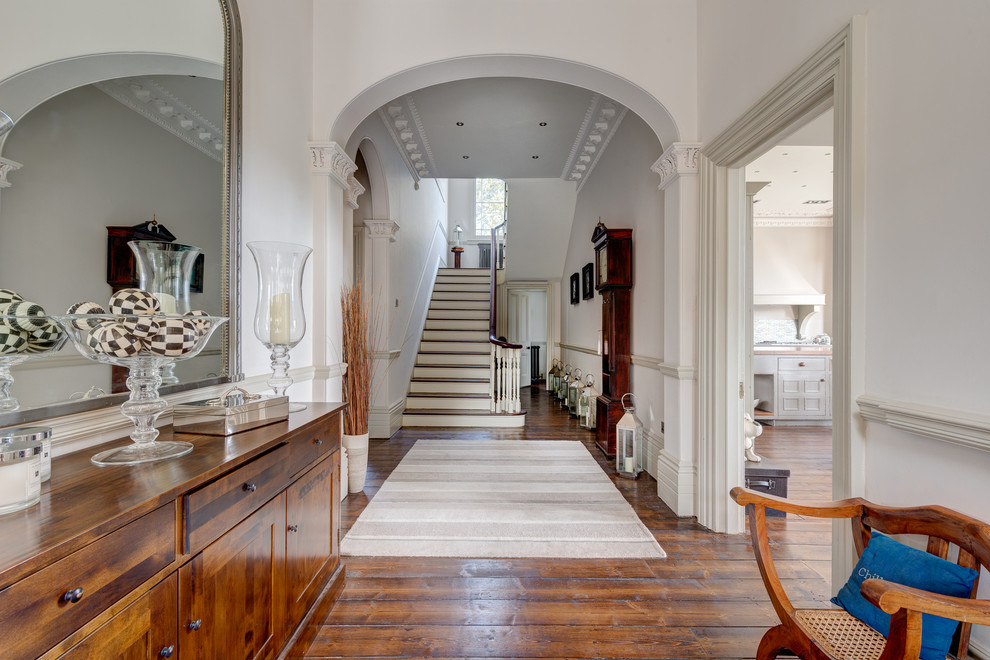 Inspiration for an expansive traditional hallway in Devon with white walls and medium hardwood floors.