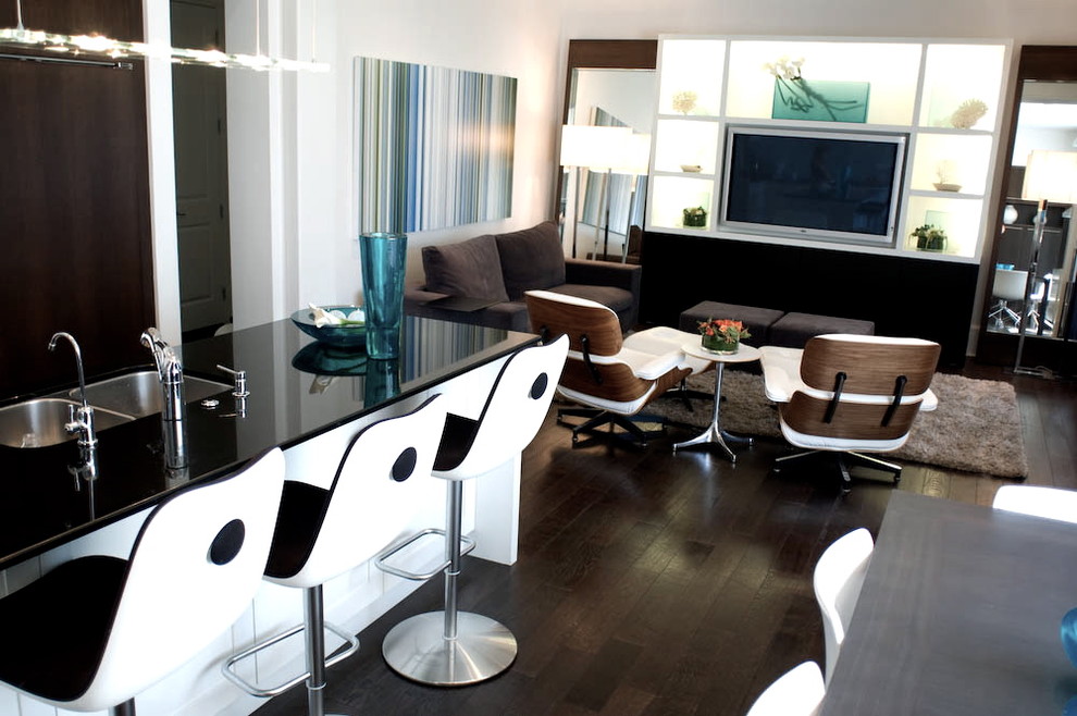 This is an example of a modern open concept living room in Vancouver with a built-in media wall.