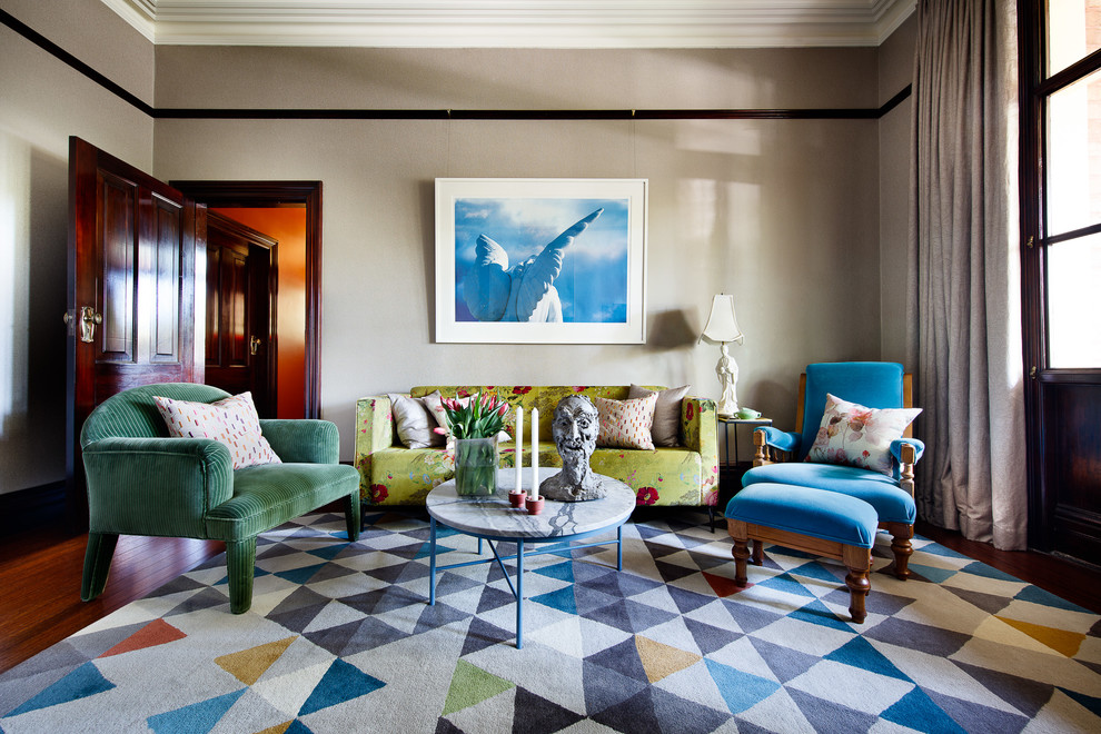 Design ideas for an eclectic living room in Sydney with medium hardwood floors, brown floor and beige walls.
