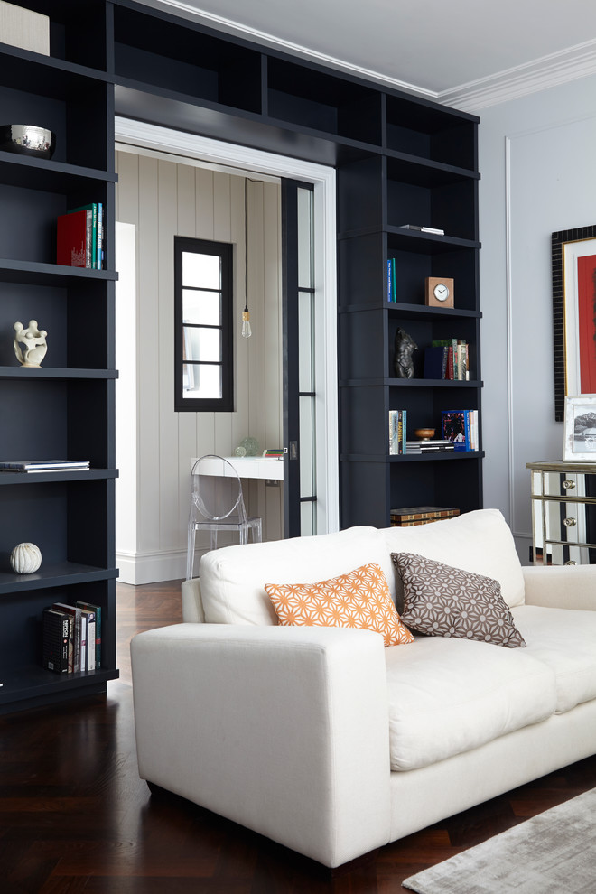 Photo of a transitional living room in London with grey walls and dark hardwood floors.