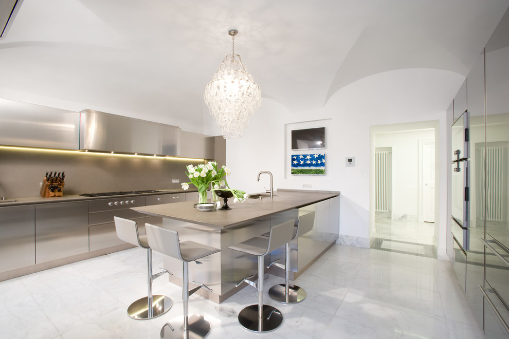 Photo of a contemporary single-wall open plan kitchen in Rome with an undermount sink, flat-panel cabinets, stainless steel cabinets, solid surface benchtops, metallic splashback, metal splashback, stainless steel appliances, marble floors and a peninsula.
