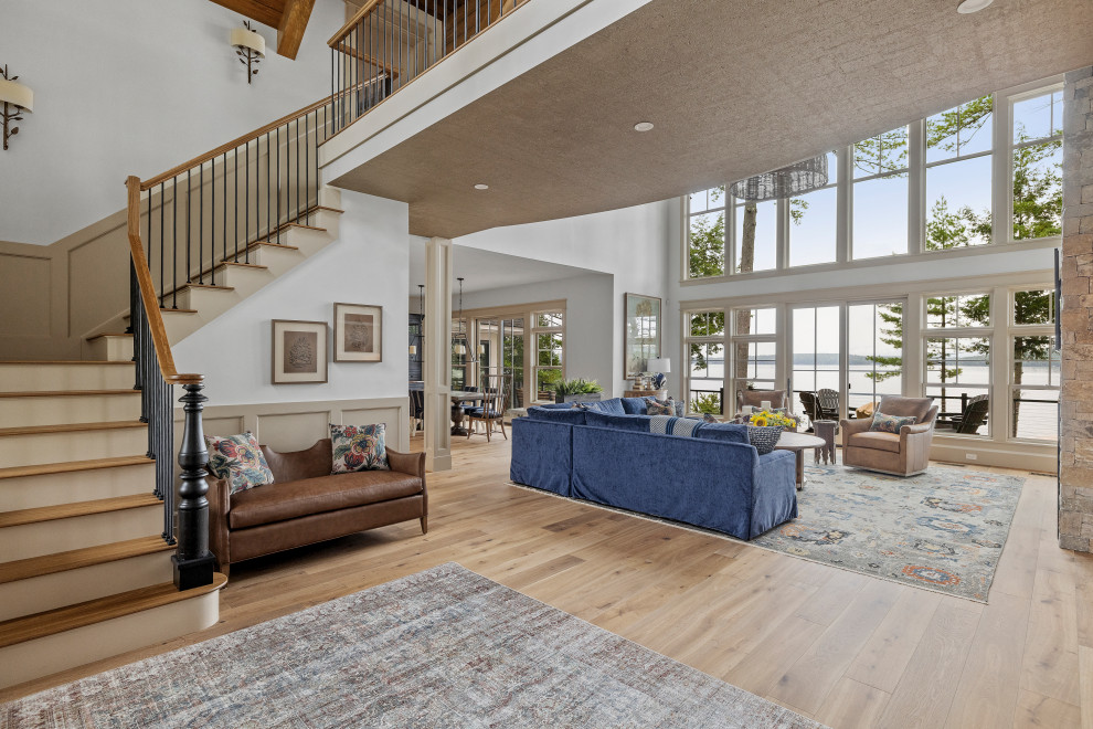 Inspiration for a huge contemporary formal and open concept medium tone wood floor, multicolored floor, vaulted ceiling and wall paneling living room remodel in Other with white walls, a standard fireplace, a stone fireplace and a wall-mounted tv