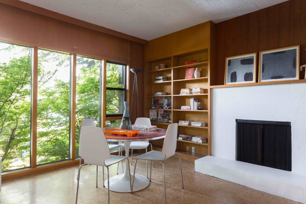 Photo of a large midcentury open concept family room in San Francisco with a game room, cork floors, a standard fireplace and a concrete fireplace surround.