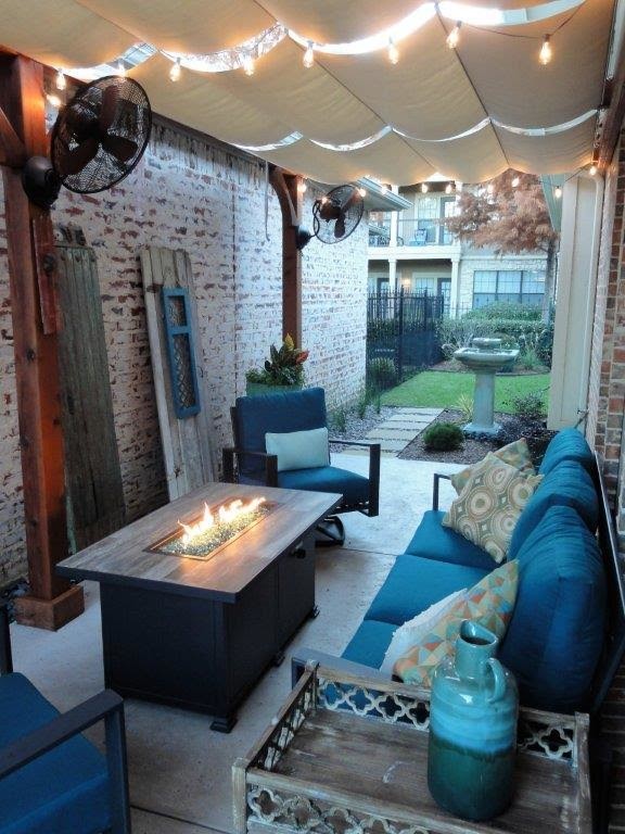 Inspiration for a small transitional side yard patio in Dallas with a fire feature, concrete pavers and an awning.