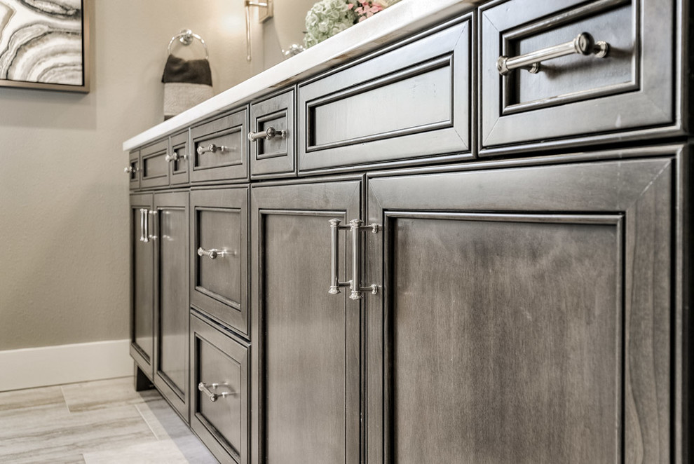 Inspiration for a mid-sized transitional master gray tile and porcelain tile ceramic tile and beige floor home design remodel with recessed-panel cabinets, dark wood cabinets, a one-piece toilet, gray walls and quartz countertops