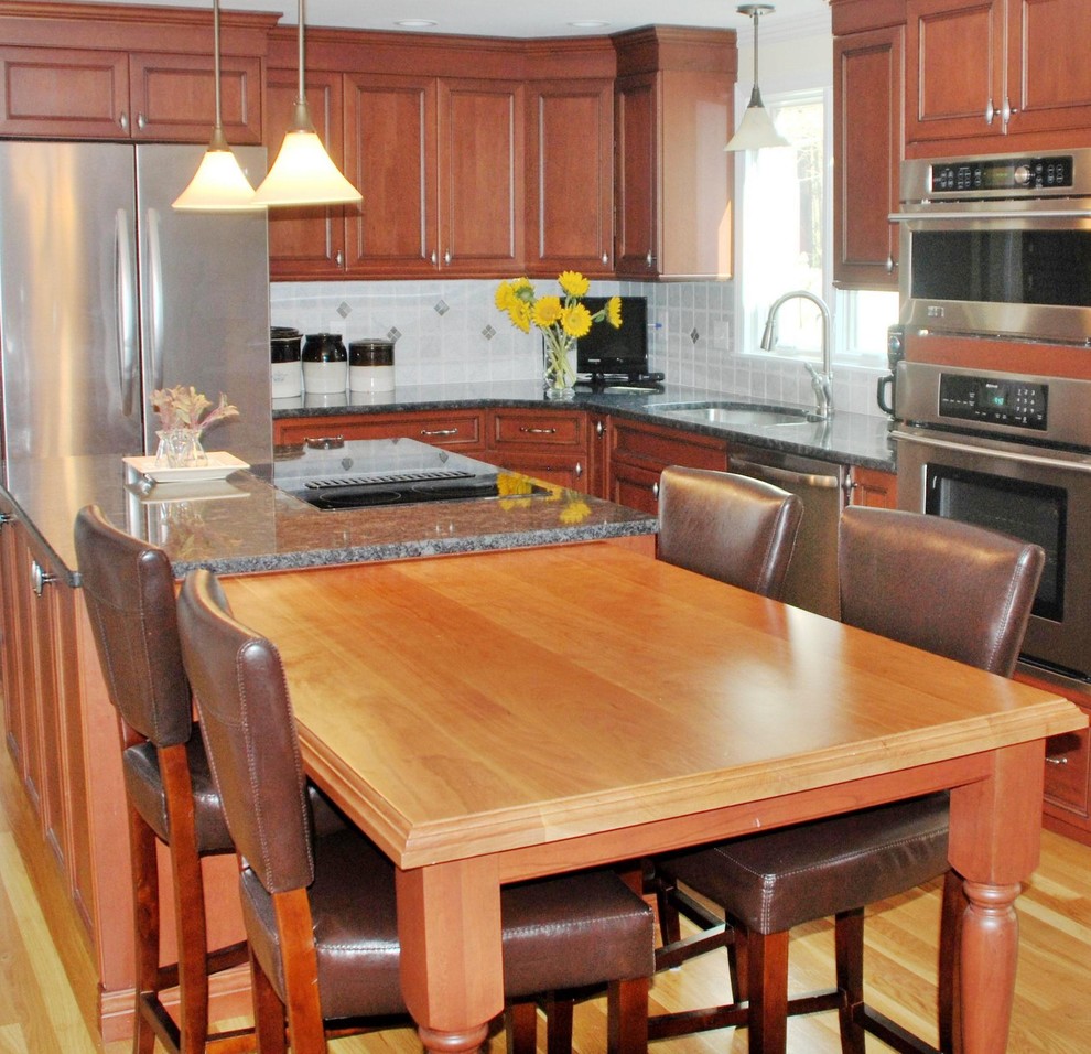 Traditional l-shaped kitchen in Boston with recessed-panel cabinets, granite benchtops and with island.