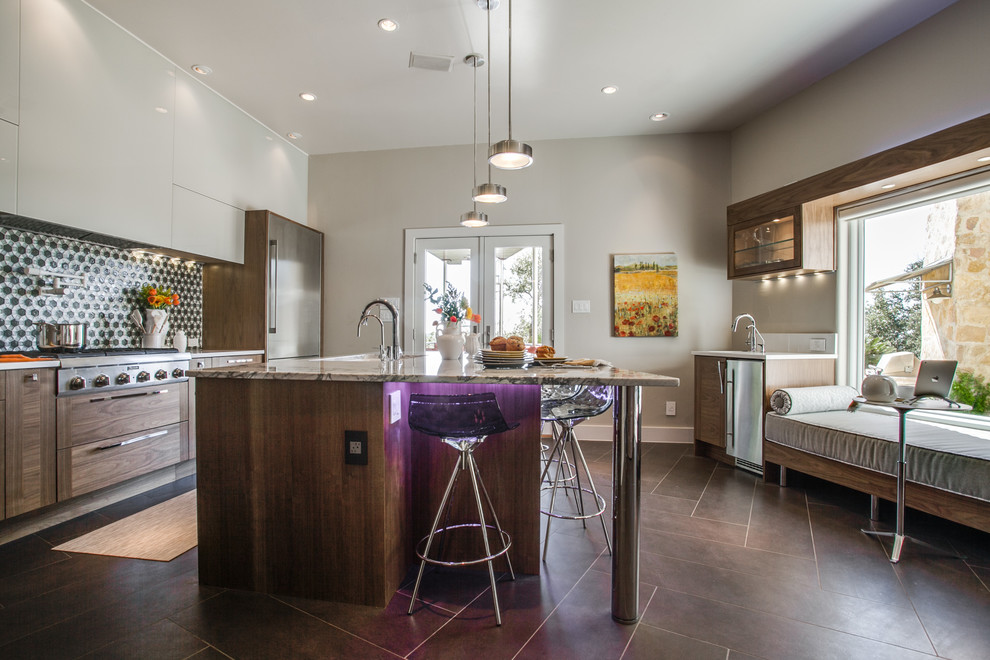 This is an example of a mid-sized contemporary l-shaped eat-in kitchen in Houston with a double-bowl sink, medium wood cabinets, quartz benchtops, grey splashback, glass tile splashback, stainless steel appliances, porcelain floors, with island, flat-panel cabinets, brown floor and white benchtop.