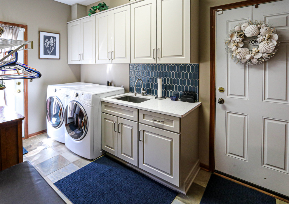 Inspiration for a small transitional single-wall dedicated laundry room in Cleveland with an undermount sink, raised-panel cabinets, white cabinets, quartz benchtops, blue splashback, cement tile splashback, grey walls, a side-by-side washer and dryer and white benchtop.
