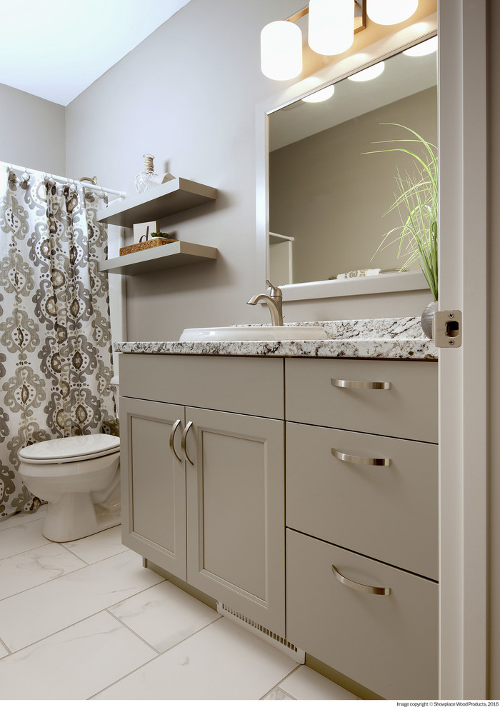 Inspiration for a mid-sized transitional 3/4 bathroom in Sacramento with recessed-panel cabinets, grey cabinets, an alcove shower, a one-piece toilet, grey walls, porcelain floors, a drop-in sink, granite benchtops, white floor, a shower curtain and multi-coloured benchtops.