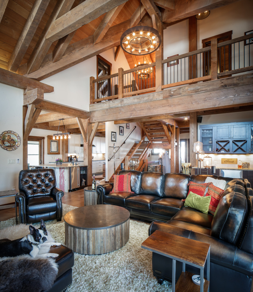 Design ideas for a mid-sized country loft-style living room in Denver with medium hardwood floors, brown floor, vaulted and wood walls.
