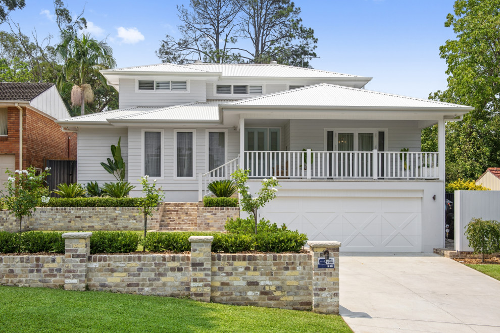 Contemporary three-storey white house exterior in Sydney with a hip roof, a metal roof, a white roof and clapboard siding.