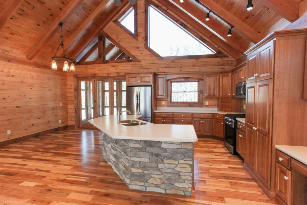 Inspiration for a rustic u-shaped light wood floor, yellow floor and wood ceiling eat-in kitchen remodel with a double-bowl sink, raised-panel cabinets, medium tone wood cabinets, wood backsplash, stainless steel appliances, an island and white countertops