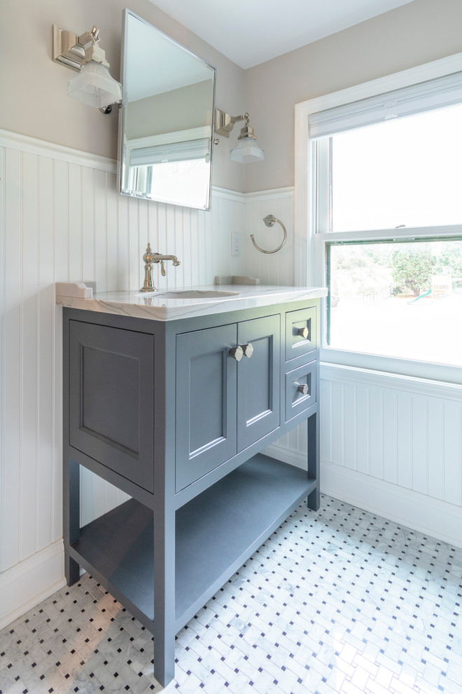 Design ideas for a small transitional master bathroom in Milwaukee with beaded inset cabinets, grey cabinets, a corner shower, a two-piece toilet, white tile, subway tile, beige walls, marble floors, an undermount sink, quartzite benchtops, grey floor, a hinged shower door and white benchtops.
