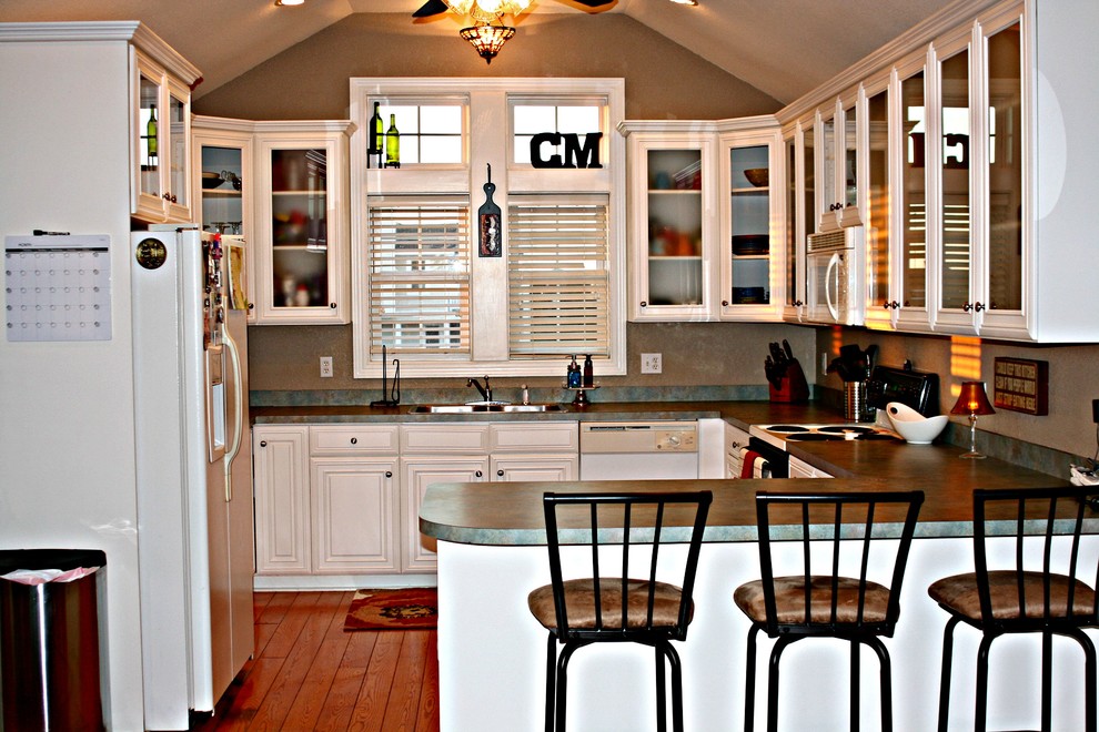 Kitchen - mid-sized transitional u-shaped medium tone wood floor kitchen idea with glass-front cabinets, white cabinets, laminate countertops and a peninsula
