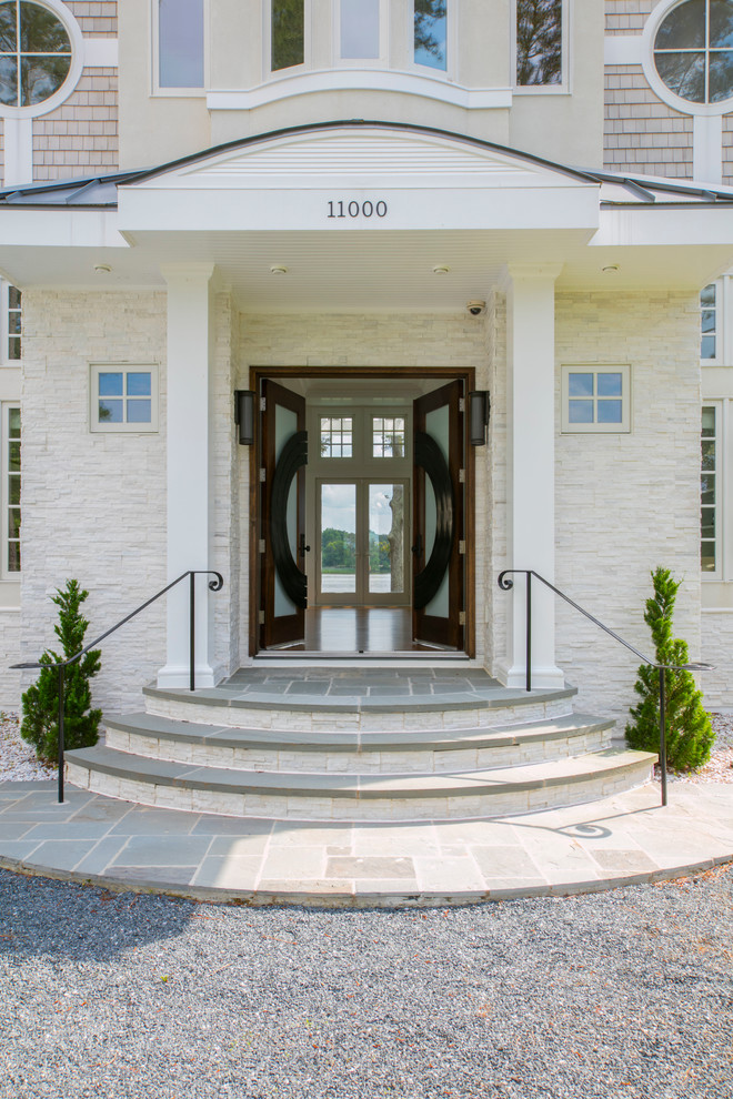 Mid-sized beach style front door in Baltimore with beige walls and a double front door.