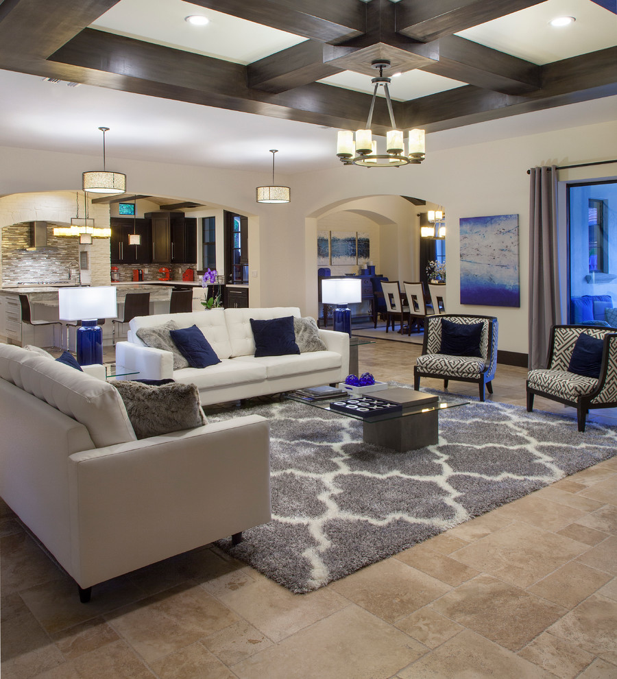 This is an example of a large contemporary open concept family room in Orlando with white walls, travertine floors, a standard fireplace, a brick fireplace surround and a wall-mounted tv.