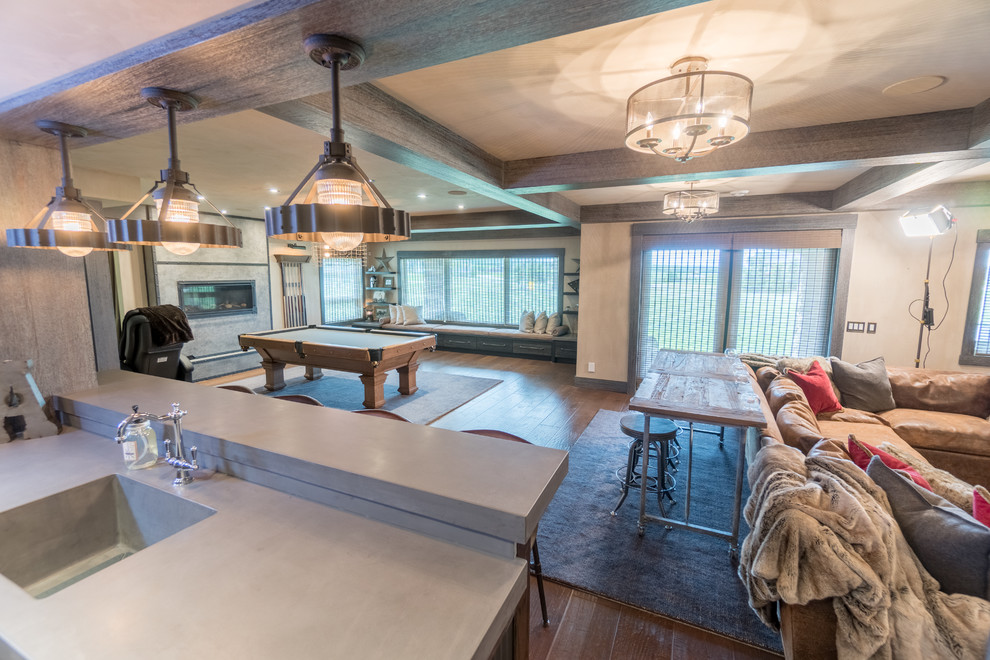Example of a large mountain style walk-out medium tone wood floor and brown floor basement design in Calgary with gray walls, a stone fireplace and a ribbon fireplace