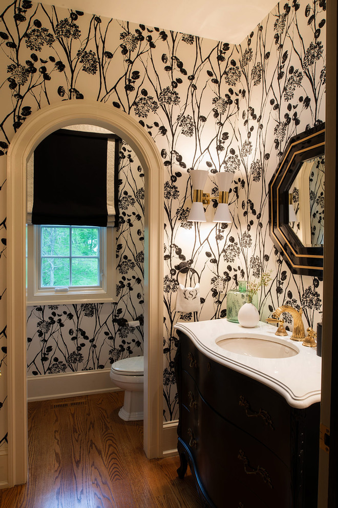 Design ideas for a large modern powder room in Philadelphia with a one-piece toilet, black walls, medium hardwood floors, an undermount sink, marble benchtops and brown floor.