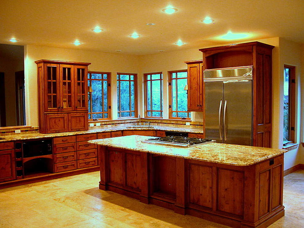 Transitional l-shaped travertine floor kitchen photo in Albuquerque with an undermount sink, recessed-panel cabinets, medium tone wood cabinets, granite countertops, beige backsplash, ceramic backsplash, stainless steel appliances and an island