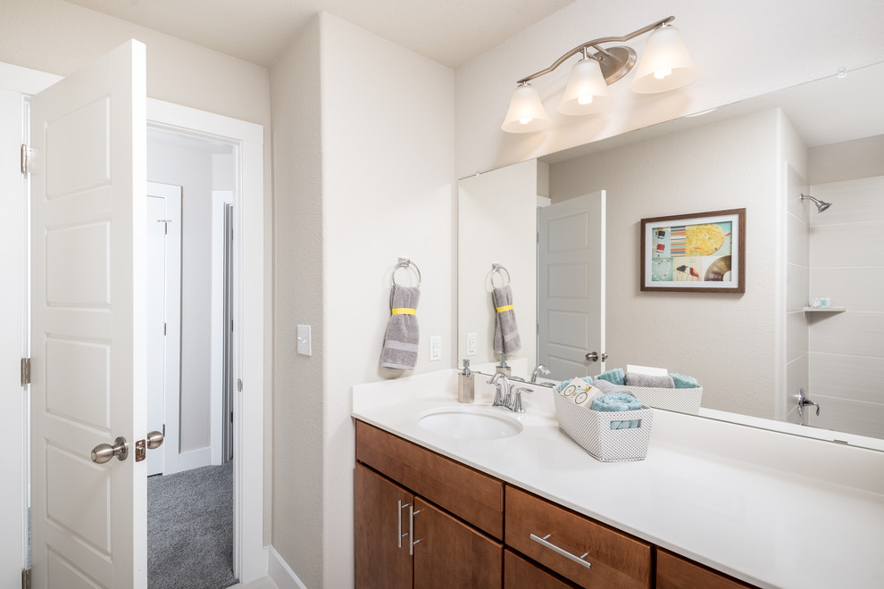Small contemporary 3/4 bathroom in Austin with flat-panel cabinets, medium wood cabinets, a drop-in tub, a shower/bathtub combo, a two-piece toilet, white tile, porcelain tile, white walls, an undermount sink and tile benchtops.