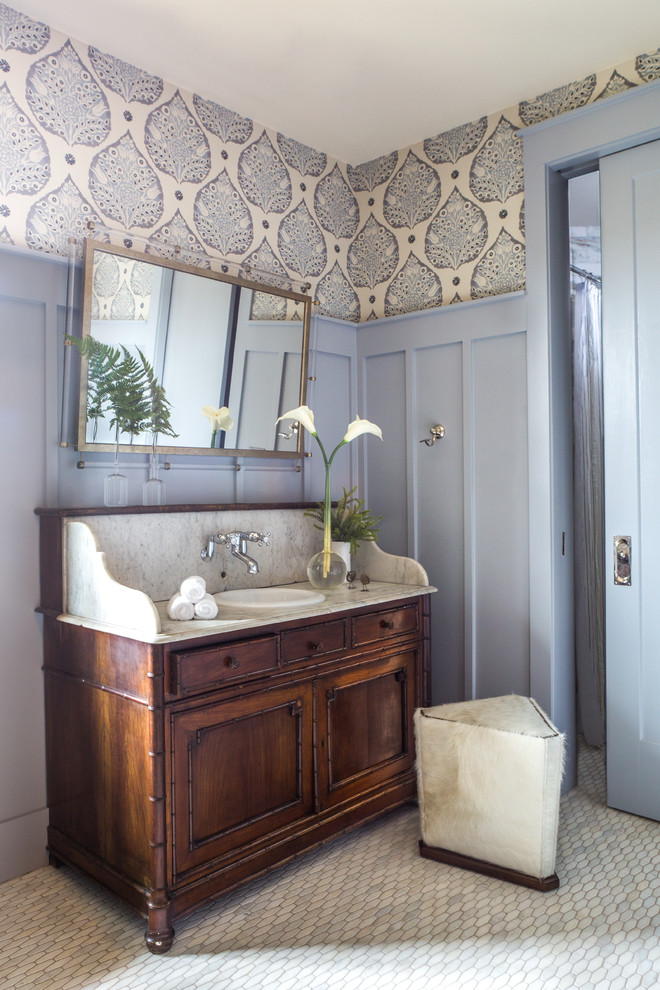 Inspiration for a mid-sized traditional master bathroom in Nashville with marble floors, a drop-in sink, marble benchtops, grey floor, white benchtops, dark wood cabinets, purple walls and recessed-panel cabinets.