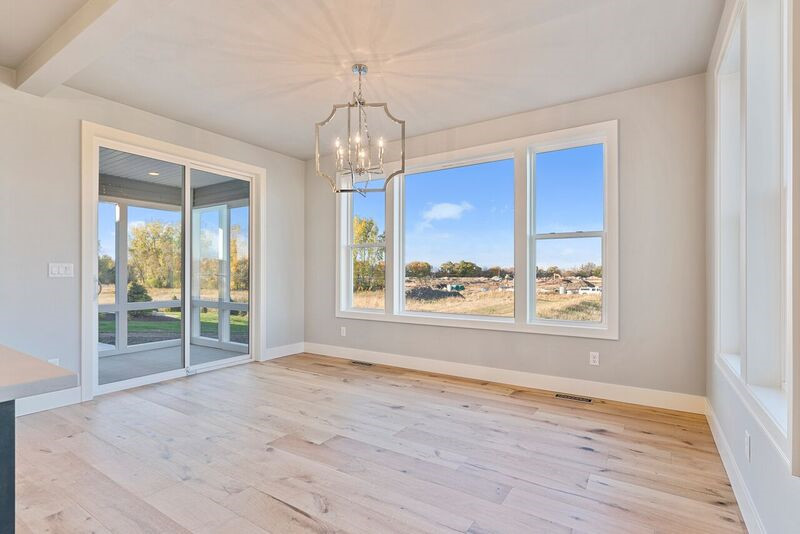 Example of a large transitional light wood floor kitchen/dining room combo design with gray walls