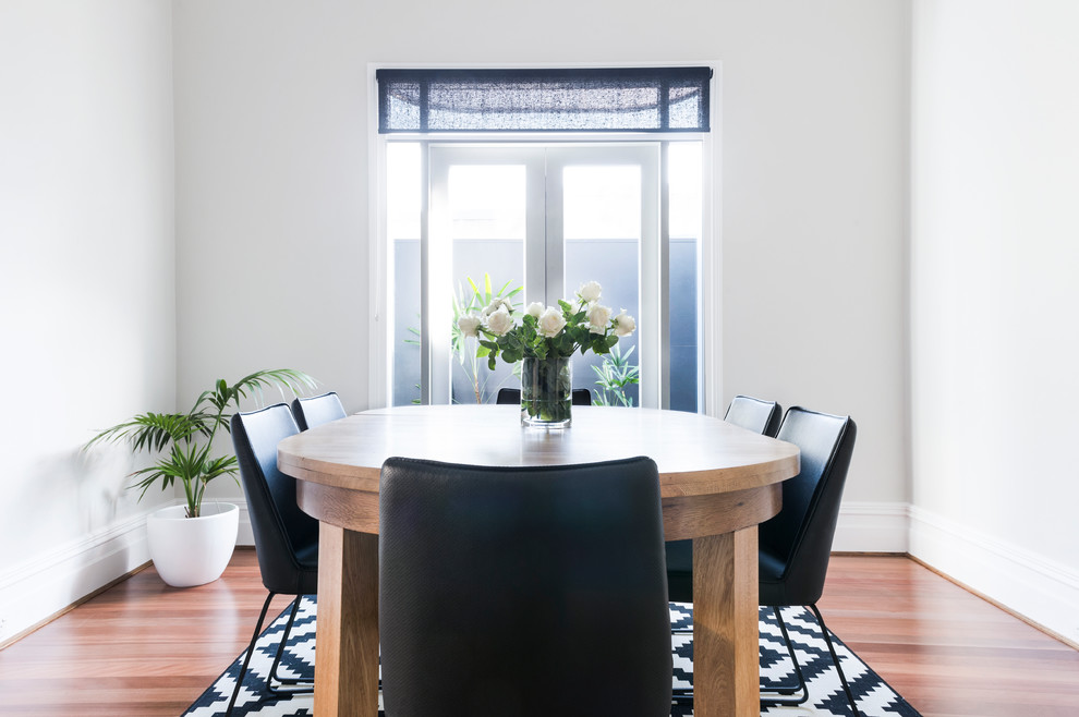 Mid-sized contemporary separate dining room in Sydney with white walls and medium hardwood floors.