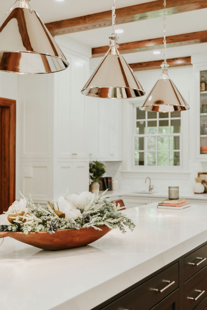 Inspiration for a large transitional u-shaped medium tone wood floor, brown floor and exposed beam eat-in kitchen remodel with a single-bowl sink, recessed-panel cabinets, white cabinets, quartz countertops, white backsplash, marble backsplash, stainless steel appliances, an island and white countertops